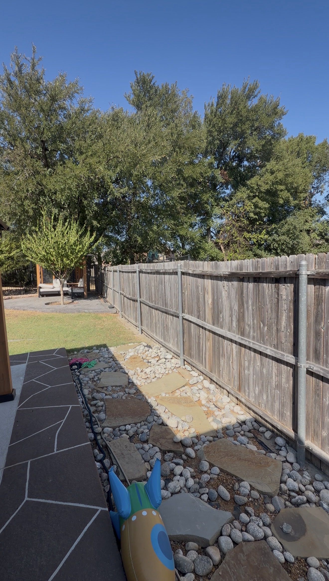 Weathered backyard fence before replacement